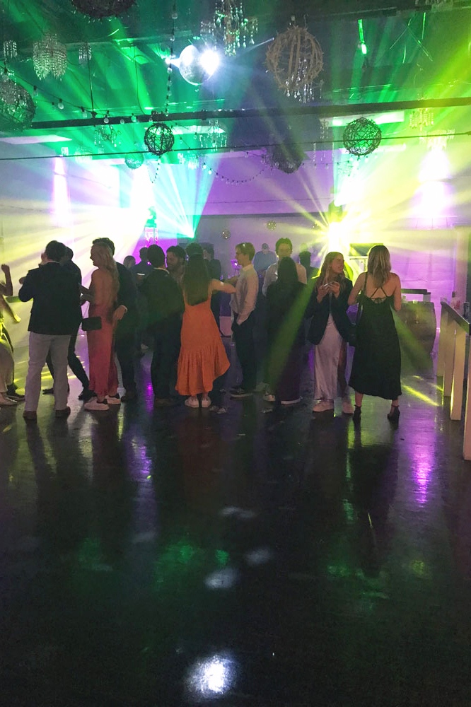 Dancers on the illuinated dance floor with the reception in full tilt and high energy at The Chateau at Forest Park